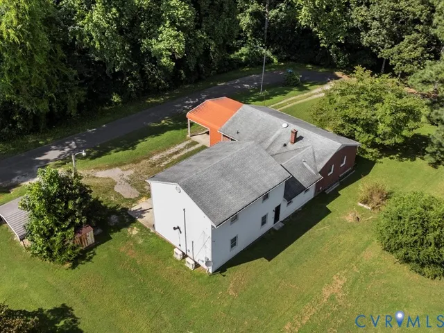 an aerial view of a house with yard basket ball court and outdoor seating
