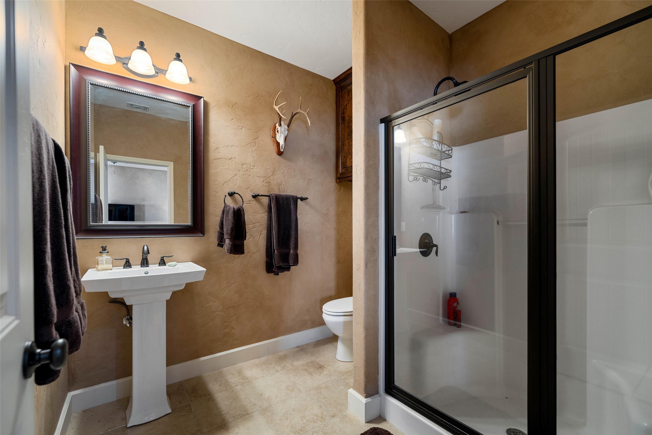 7702 Ranch Road 965 Llano, TX 78643 - Photo 15 of 40 a bathroom with a sink and mirror with toilet