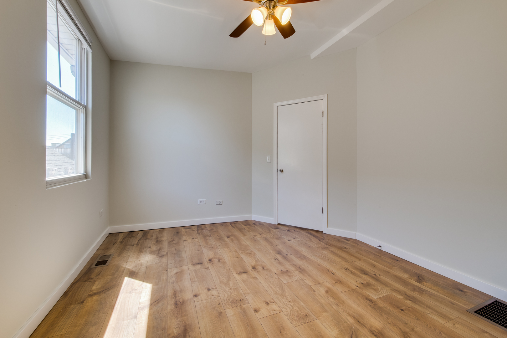 1246 North Cleaver Street, Unit 2R Chicago, IL 60642 - Photo 11 of 15 an empty room with a window and a ceiling fan