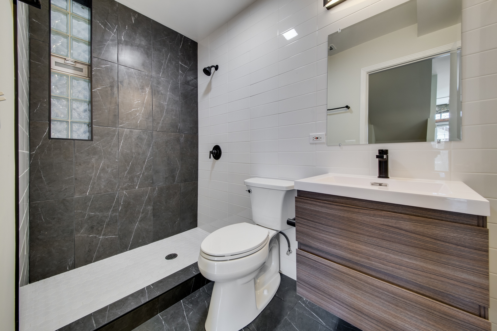 1246 North Cleaver Street, Unit 2R Chicago, IL 60642 - Photo 12 of 15 a bathroom with a sink a toilet and shower