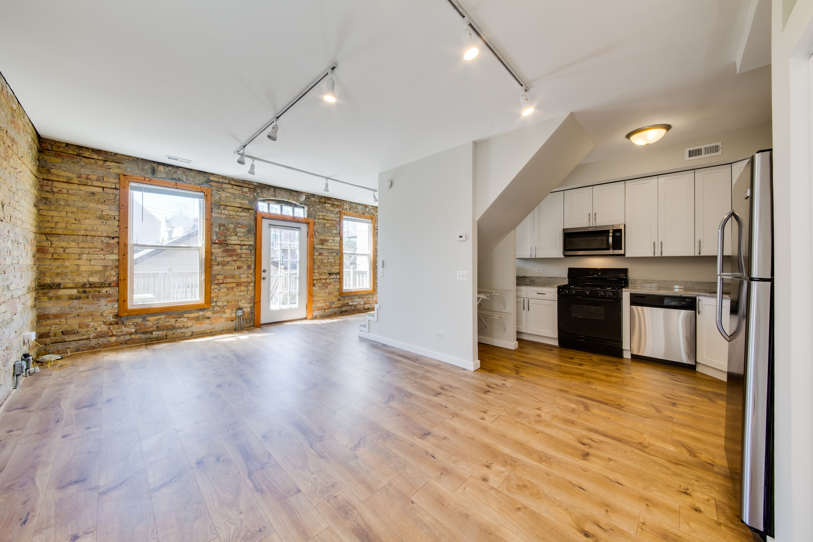1246 North Cleaver Street, Unit 2R Chicago, IL 60642 - Photo 4 of 15 a view of kitchen with refrigerator and wooden floor