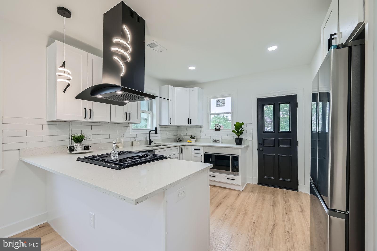 3814 Cedardale Road Baltimore, MD 21215 - Photo 11 of 28 a kitchen with stainless steel appliances a sink stove and refrigerator
