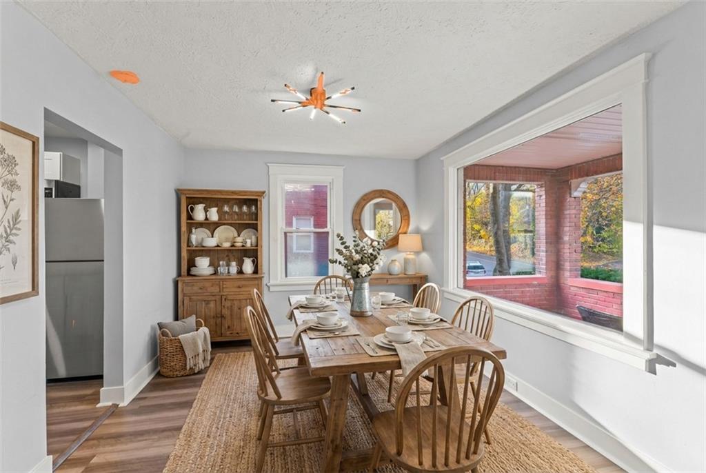 433 Green Street Homestead, PA 15120 - Photo 11 of 33 a view of a dining room with furniture a chandelier and wooden floor