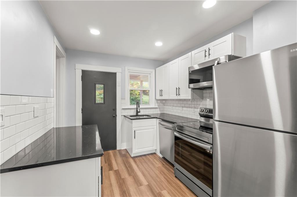 433 Green Street Homestead, PA 15120 - Photo 11 of 23 a kitchen with a refrigerator and a stove top oven