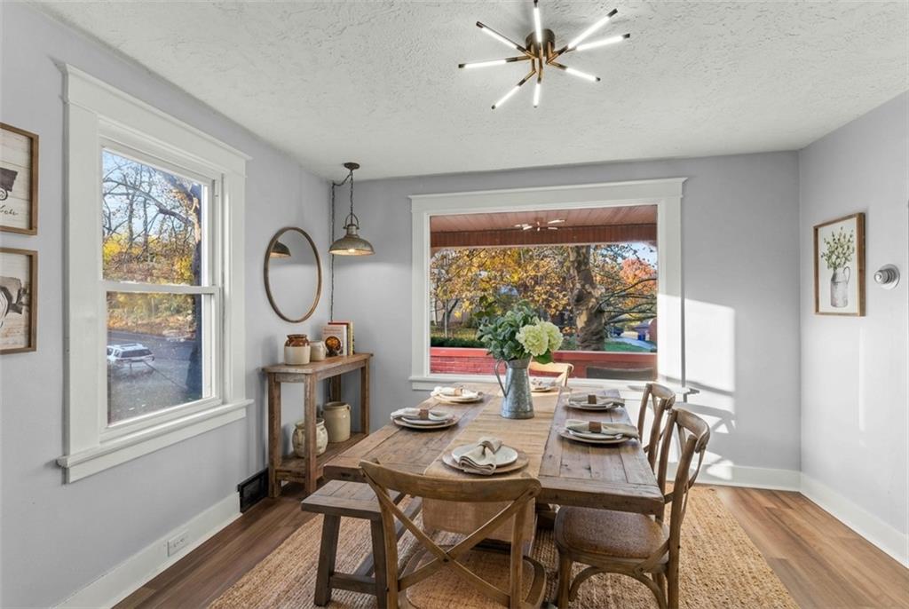 433 Green Street Homestead, PA 15120 - Photo 13 of 33 a dining room with furniture a chandelier and wooden floor