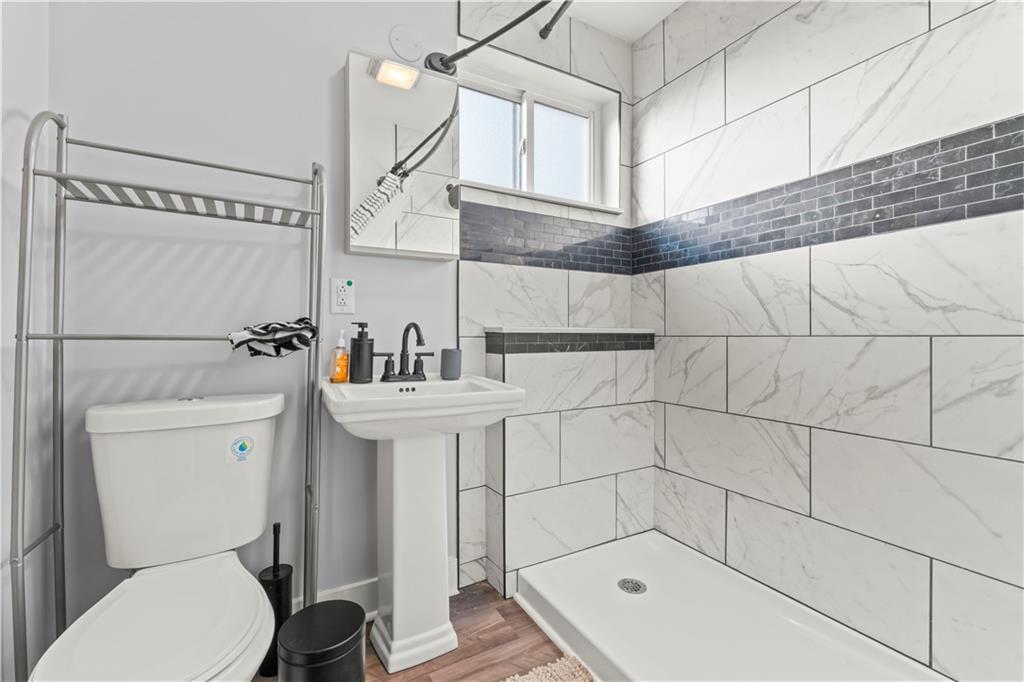 433 Green Street Homestead, PA 15120 - Photo 14 of 23 a bathroom with a sink a toilet and shower