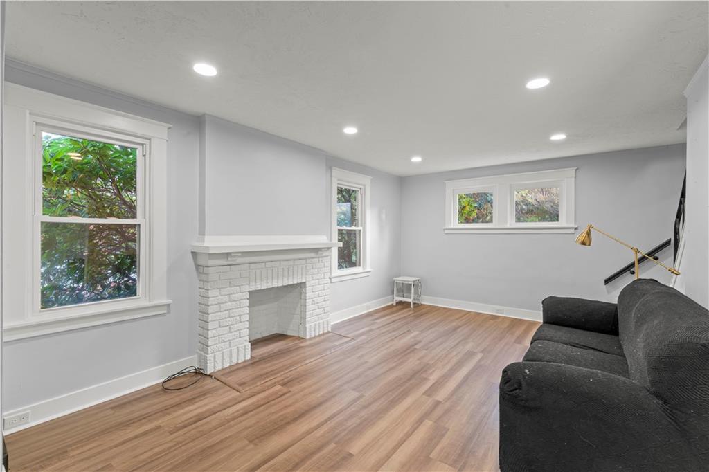 433 Green Street Homestead, PA 15120 - Photo 7 of 23 a view of a livingroom with a fireplace wooden floor and windows