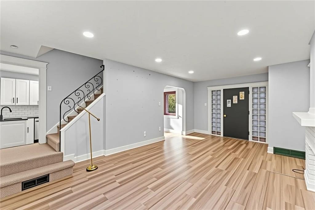 433 Green Street Homestead, PA 15120 - Photo 8 of 33 a view of an empty room with wooden floor and stairs