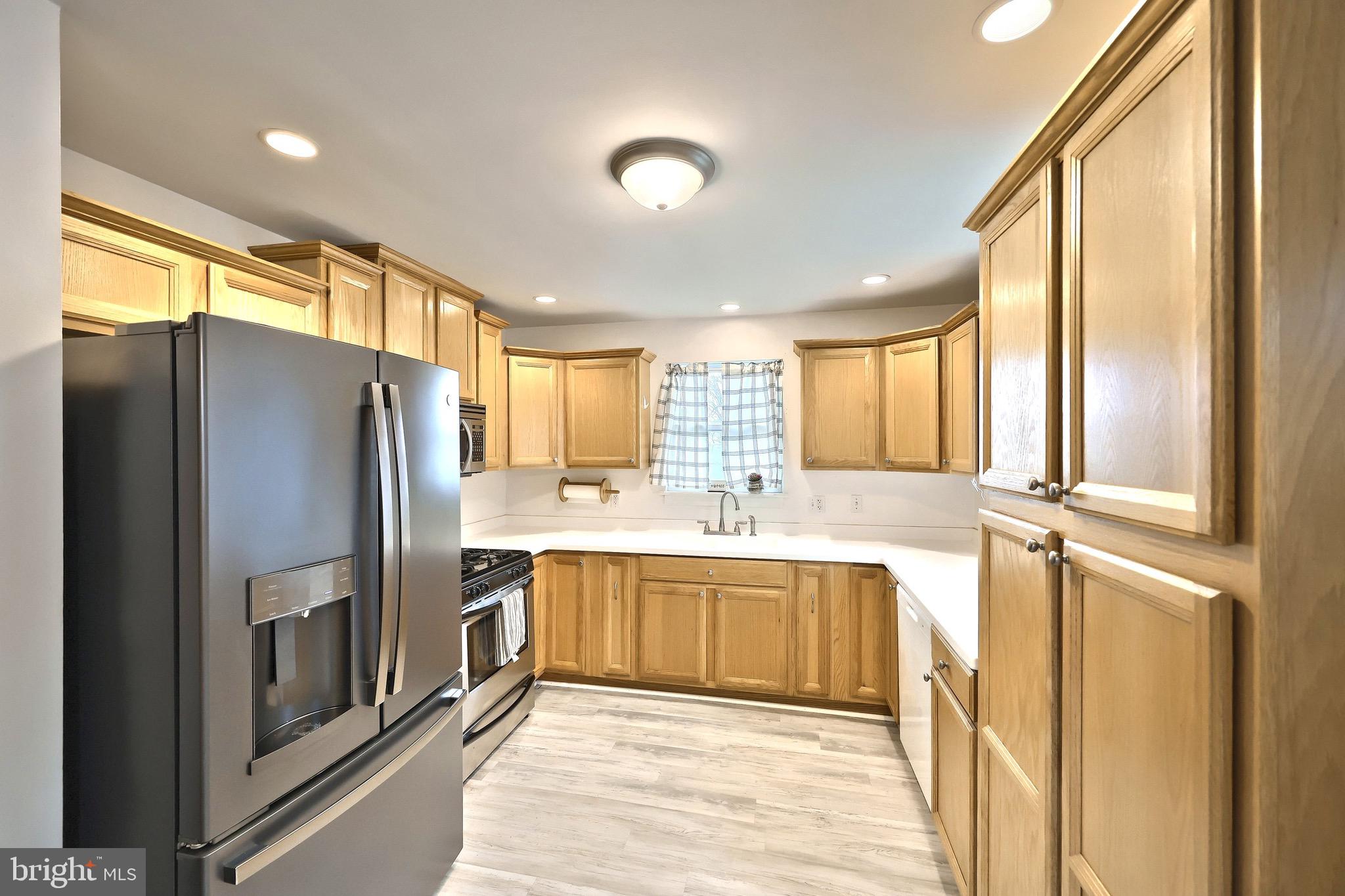 4619 South Road Harrisburg, PA 17109 - Photo 13 of 29 a large kitchen with a large window and stainless steel appliances