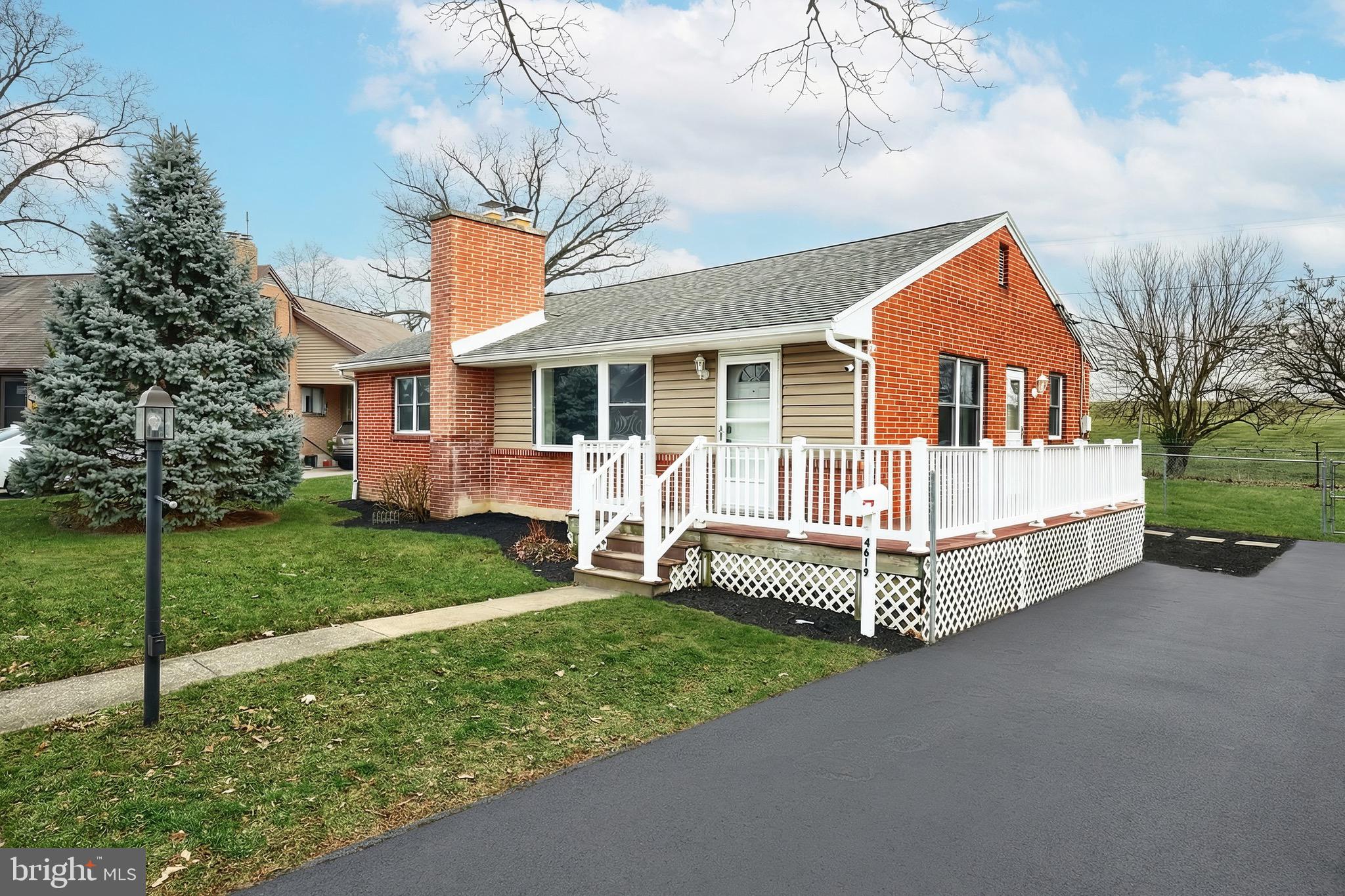 4619 South Road Harrisburg, PA 17109 - Photo 2 of 29 a front view of a house with a garden and deck