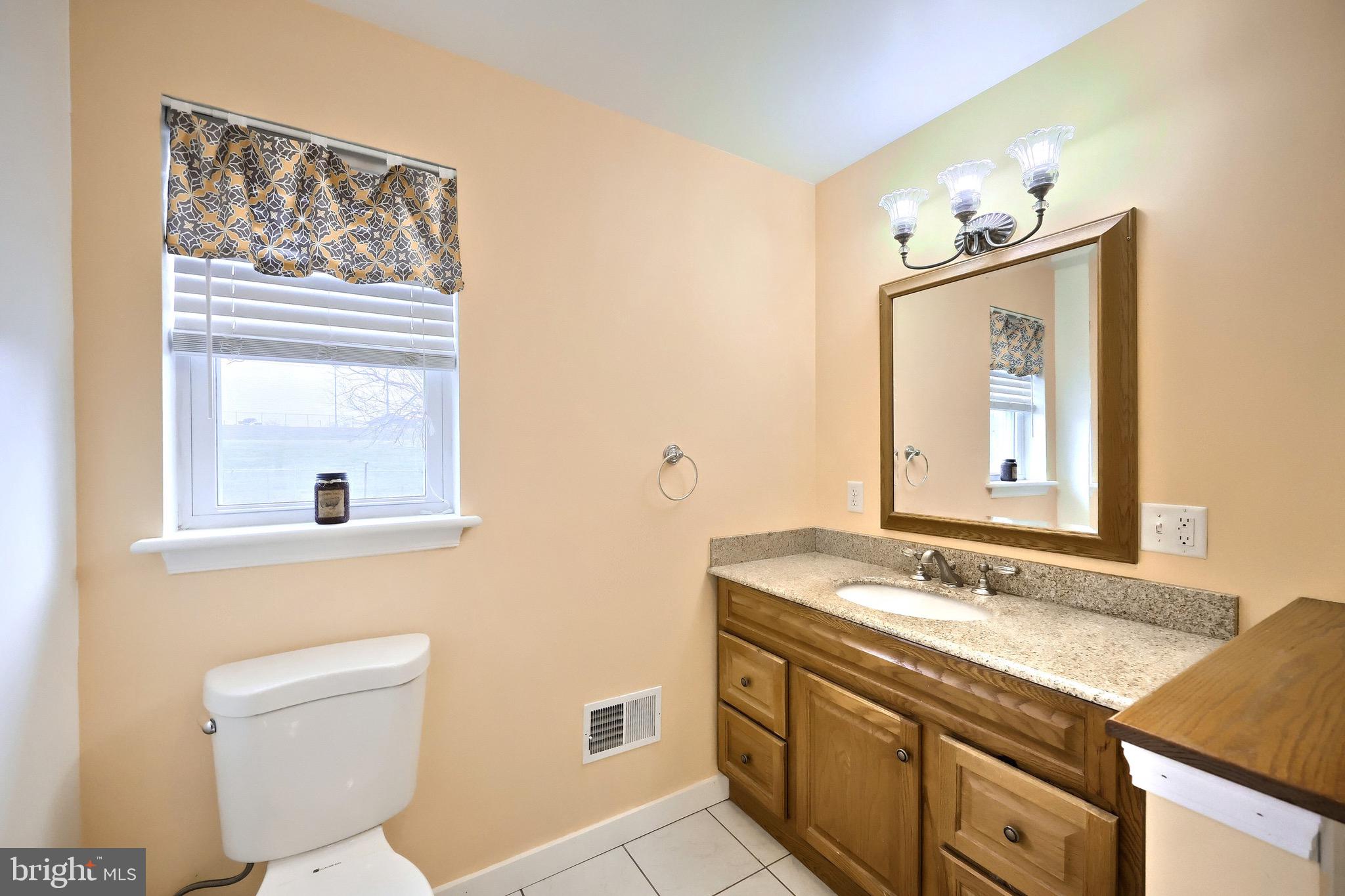 4619 South Road Harrisburg, PA 17109 - Photo 21 of 29 a bathroom with a granite countertop sink mirror and toilet
