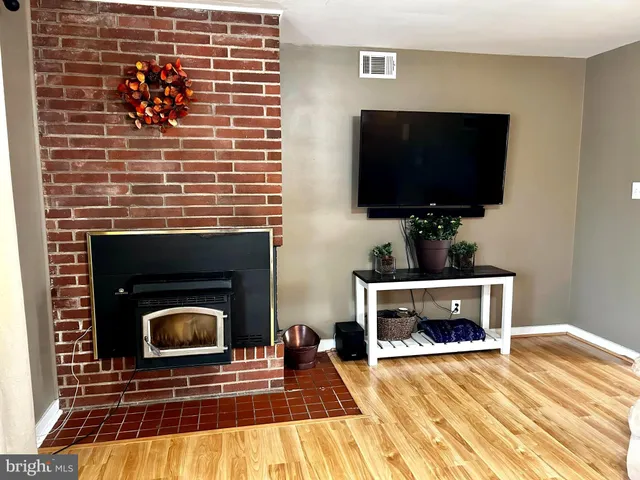 a living room with a fireplace a flat screen tv and a fireplace