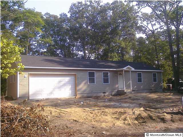 409 Riverside Drive Bayville, NJ 08721 - Photo 2 of 3 a front view of a house with a yard and garage