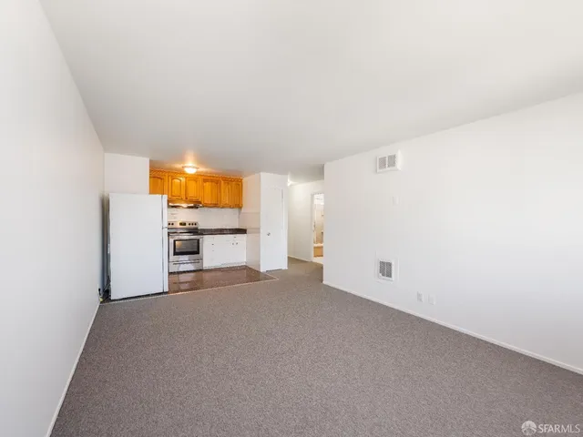 a view of a kitchen with refrigerator and washer