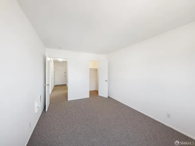 a kitchen with a refrigerator and a stove top oven