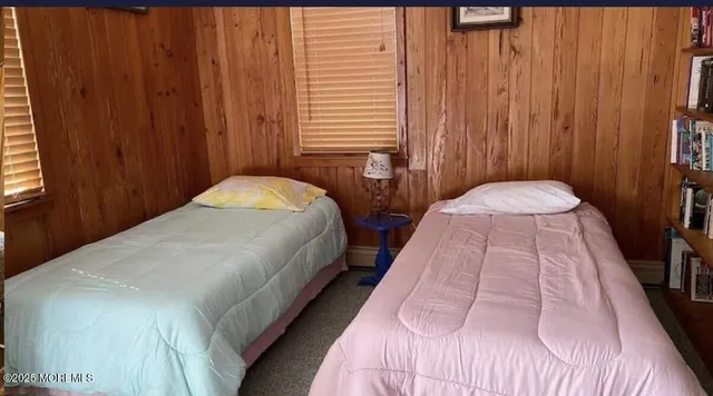 a bedroom with bed and window