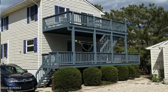 a view of a house with a small yard and wooden fence