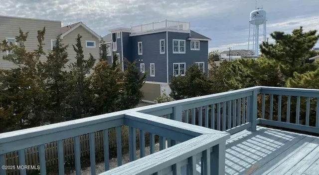 a view of balcony with wooden floor and fence