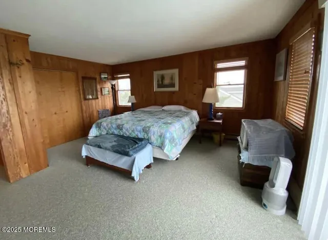 a spacious bedroom with a bed and a window