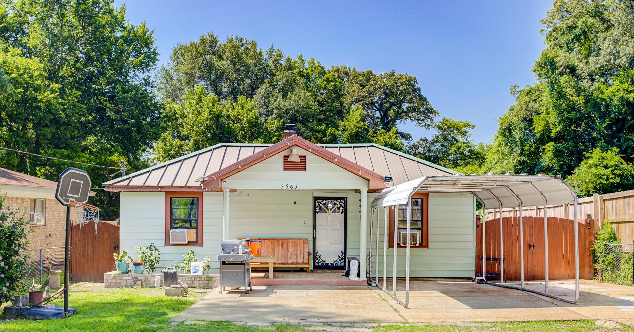 3663 Rhea Avenue Memphis, TN 38122 - Photo 1 of 15 Bungalow-style house with a standing seam roof, a gate, a detached carport, a metal roof, and a chimney