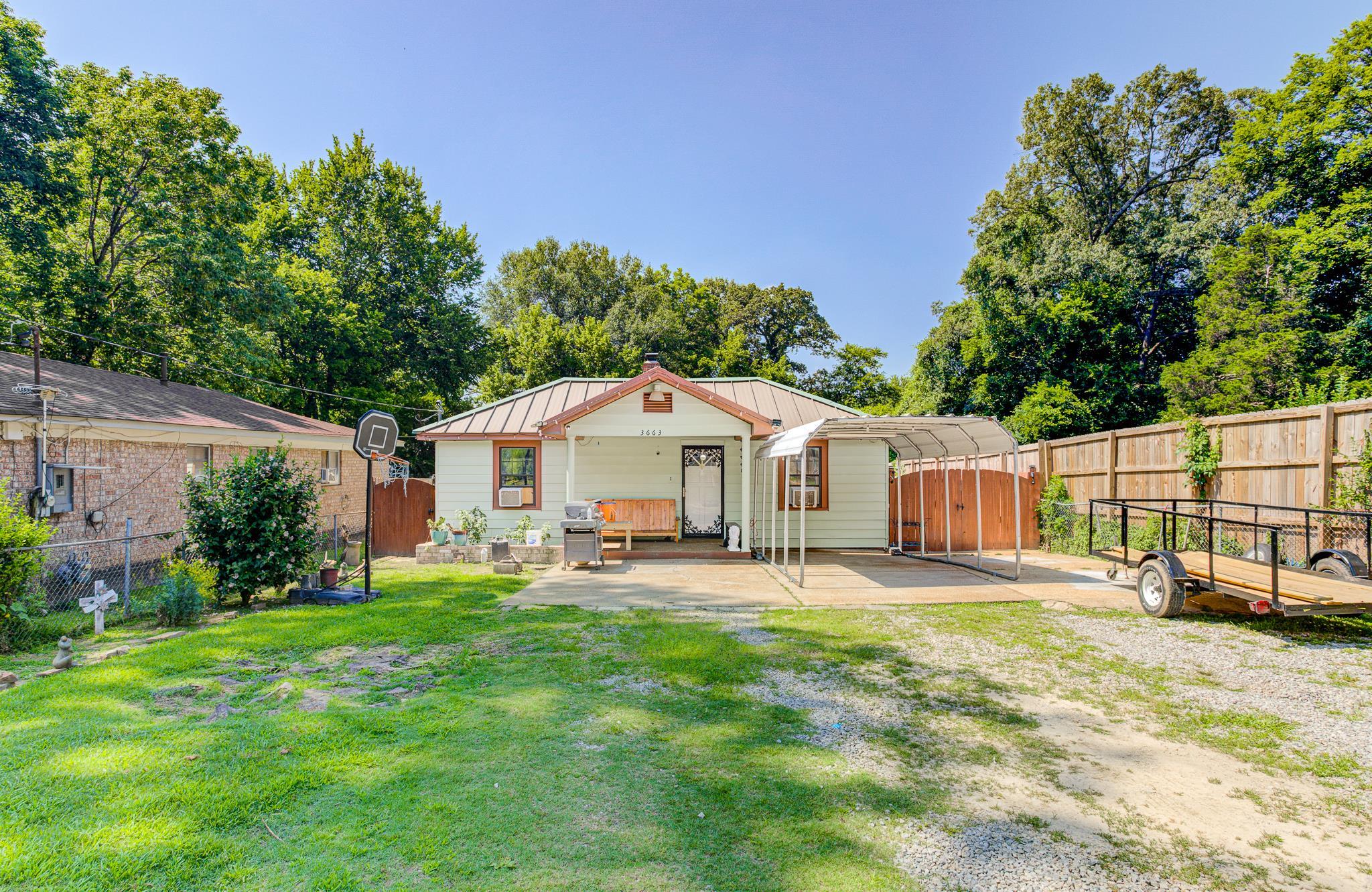 3663 Rhea Avenue Memphis, TN 38122 - Photo 2 of 15 Rear view of property featuring a metal roof, a standing seam roof, and a chimney
