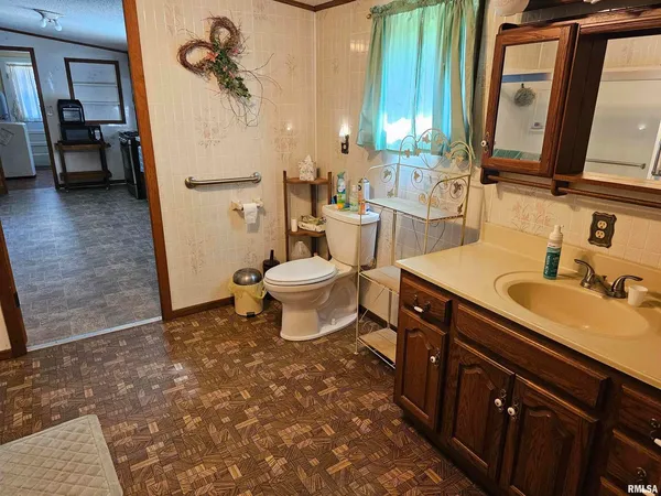a bathroom with a sink a toilet and a mirror