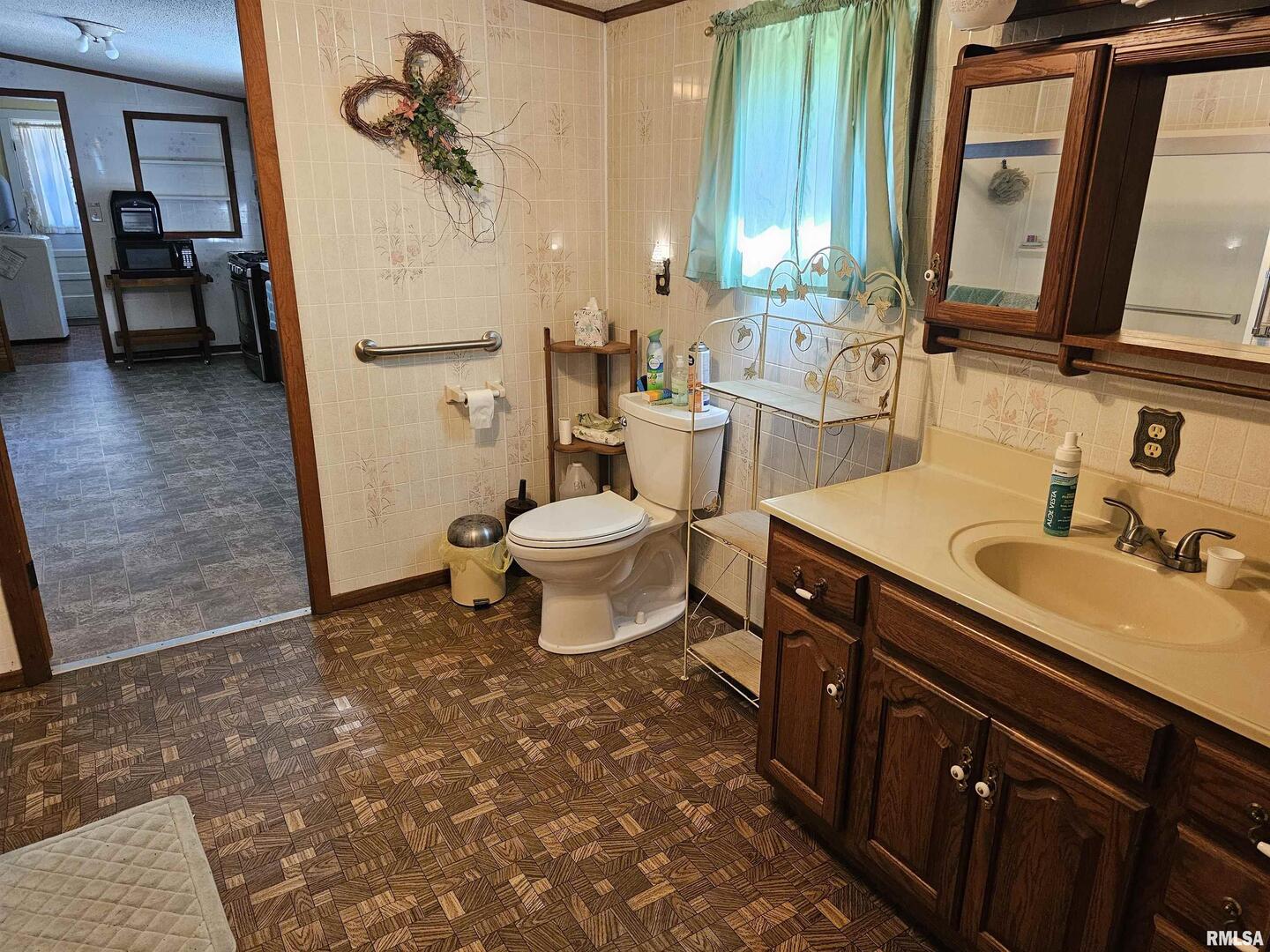 4864 Boaz Road Grand Chain, IL 62941 - Photo 21 of 32 a bathroom with a sink a toilet and a mirror
