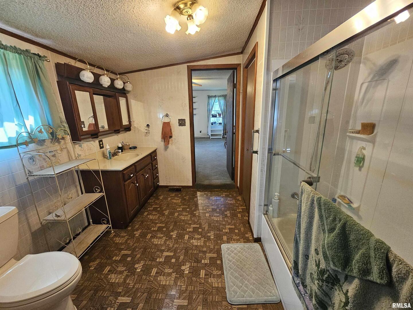 4864 Boaz Road Grand Chain, IL 62941 - Photo 22 of 32 a bathroom with a sink a toilet a mirror and shower
