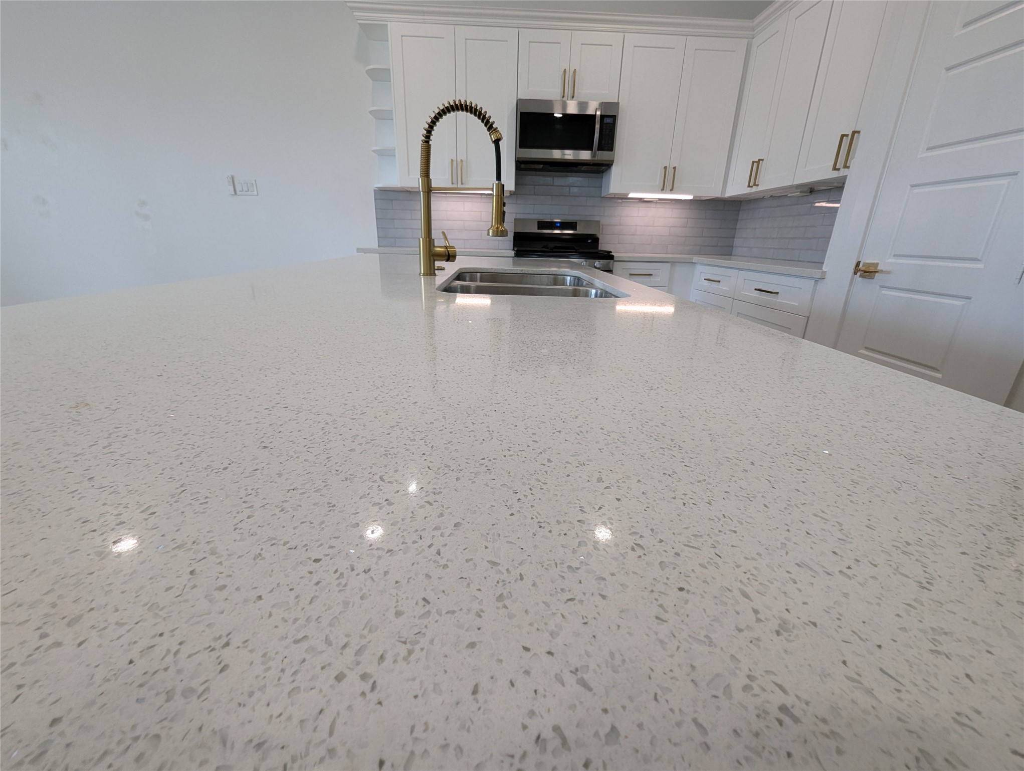 4913 Fisk Street Houston, TX 77009 - Photo 7 of 27 a kitchen with kitchen island a stove and a sink