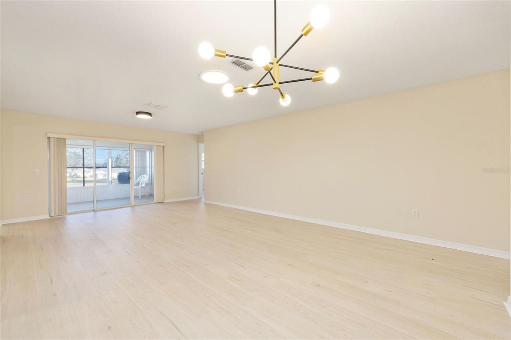 17549 Southeast 115th Terrace Road Summerfield, FL 34491 - Photo 18 of 56 a view of empty room with wooden floor
