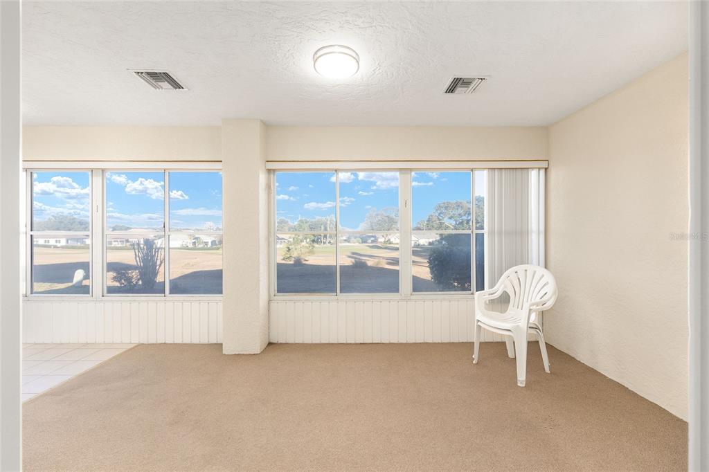 17549 Southeast 115th Terrace Road Summerfield, FL 34491 - Photo 36 of 56 a living room with furniture and a large window