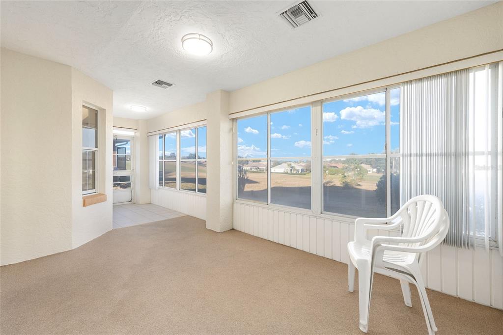17549 Southeast 115th Terrace Road Summerfield, FL 34491 - Photo 37 of 56 a view of an empty room with wooden floor and a window