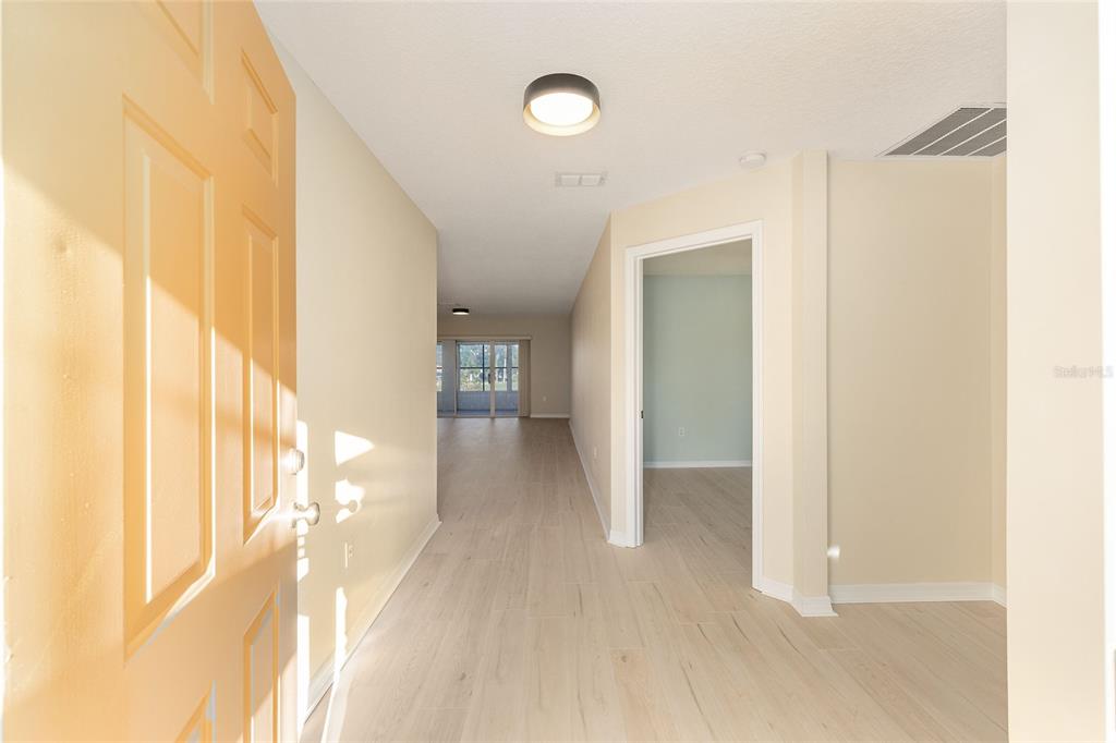 17549 Southeast 115th Terrace Road Summerfield, FL 34491 - Photo 5 of 56 a view of a hallway with wooden floor and cabinet