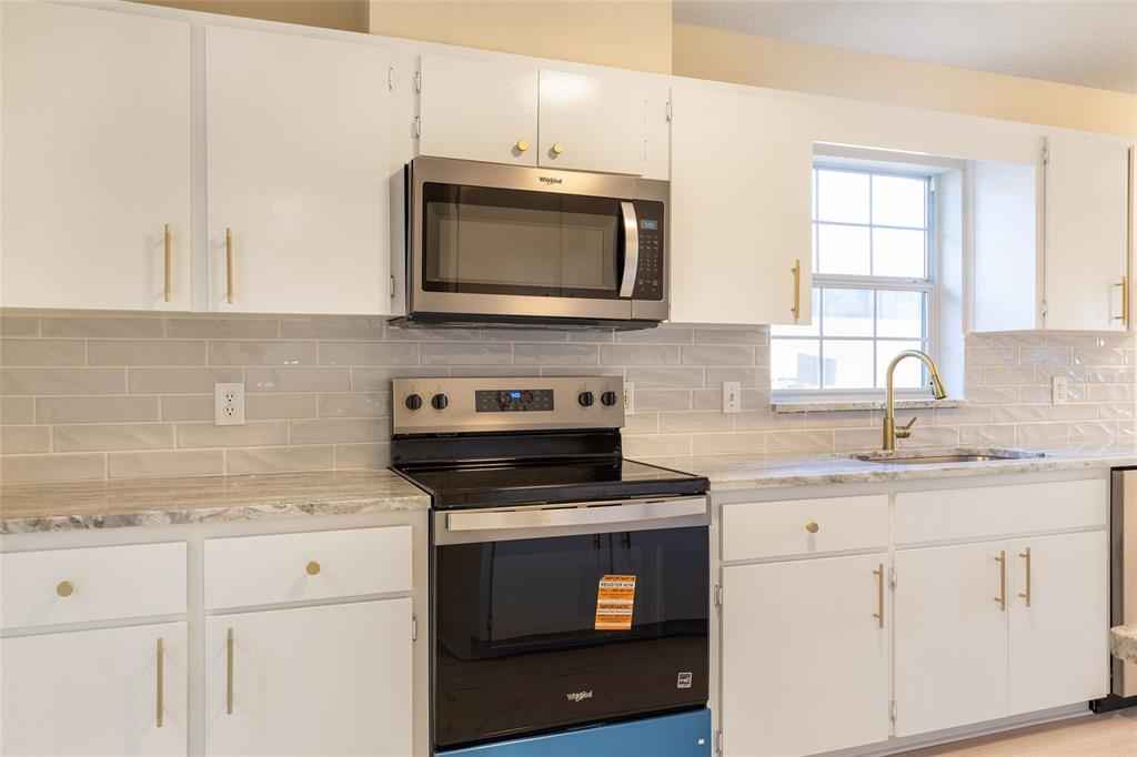 17549 Southeast 115th Terrace Road Summerfield, FL 34491 - Photo 8 of 56 a kitchen with granite countertop white cabinets appliances and a window