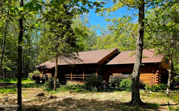 a view of house with yard and swimming pool