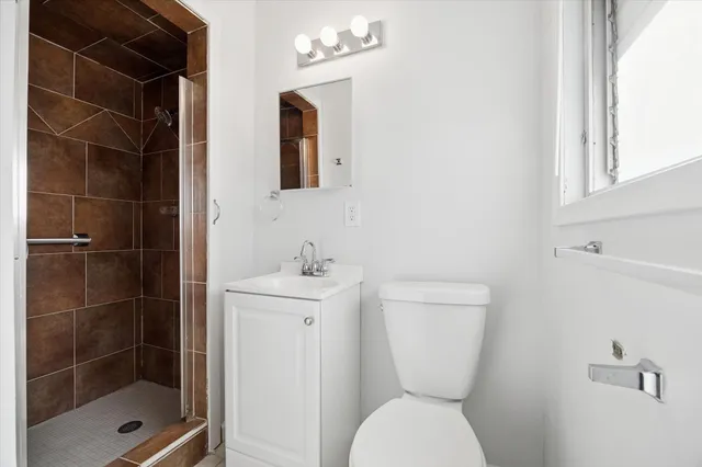 a bathroom with a toilet sink and shower