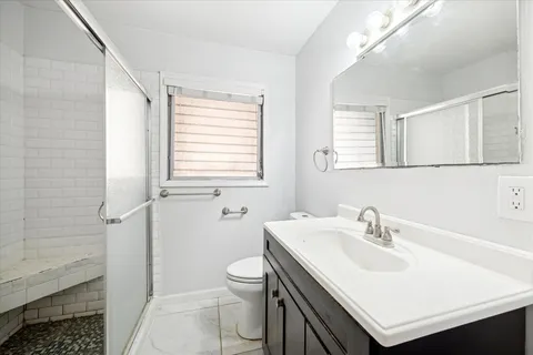 a bathroom with a sink toilet and shower