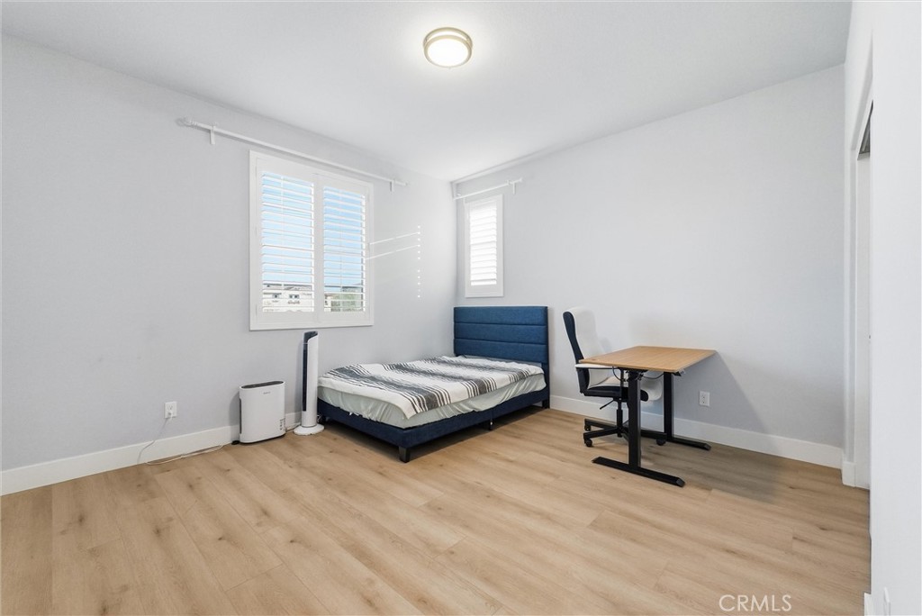 15828 Kingston Road Chino Hills, CA 91709 - Photo 20 of 28 a bedroom with a bed a table and a window