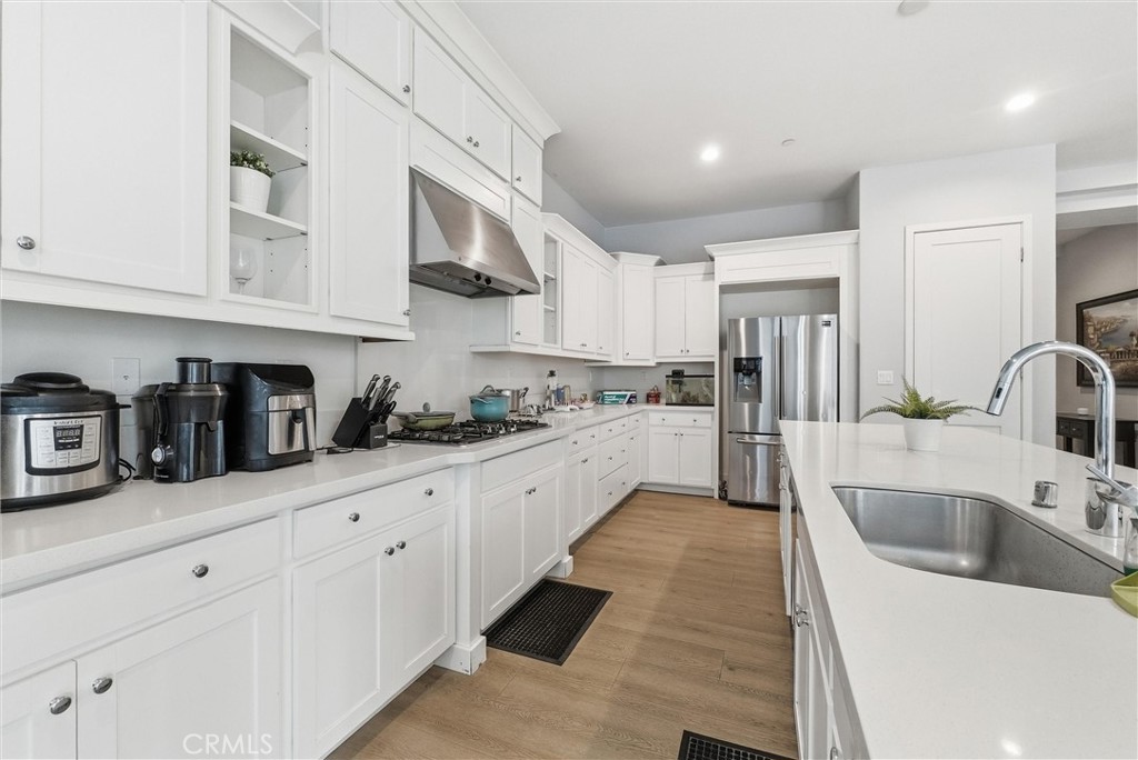 15828 Kingston Road Chino Hills, CA 91709 - Photo 5 of 28 a large kitchen with stainless steel appliances lots of counter space sink and cabinets