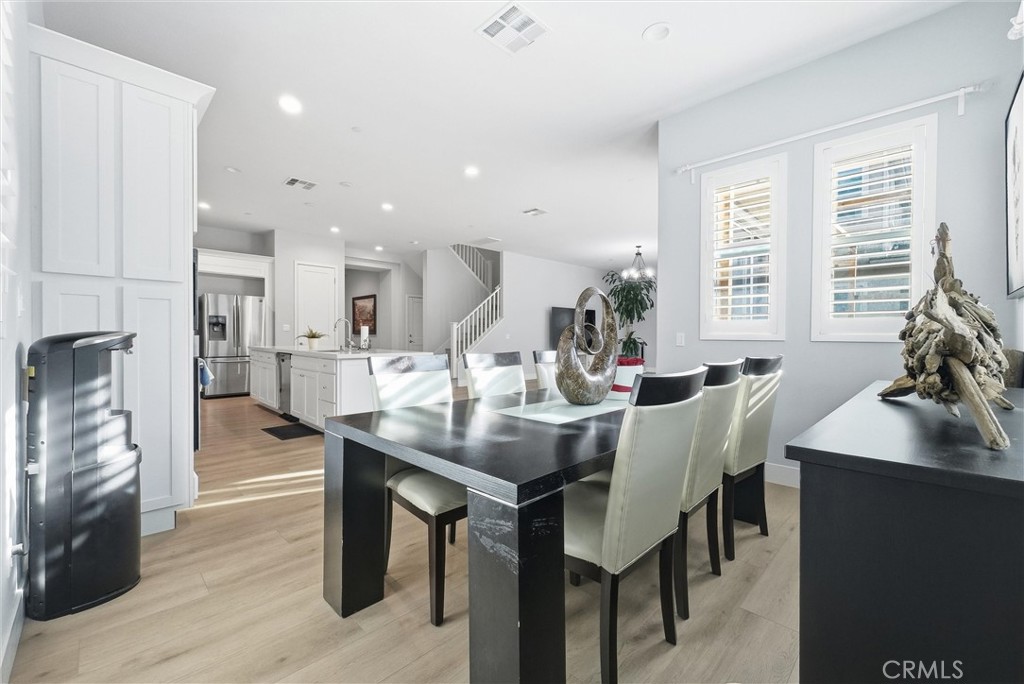 15828 Kingston Road Chino Hills, CA 91709 - Photo 9 of 28 a view of a dining room with furniture and a potted plant