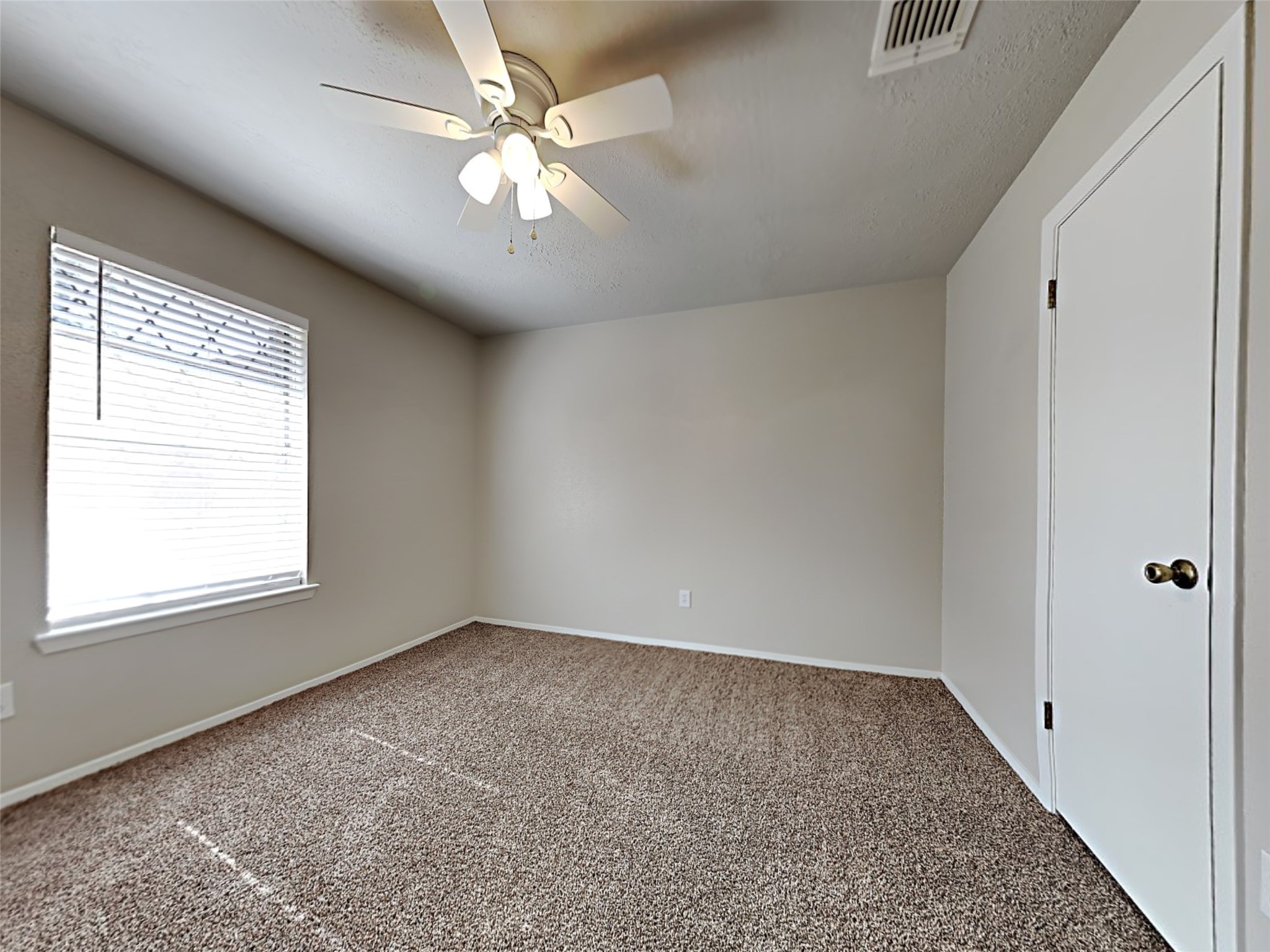 14919 Wainsfield Lane Channelview, TX 77530 - Photo 6 of 17 an empty room with chandelier fan and windows