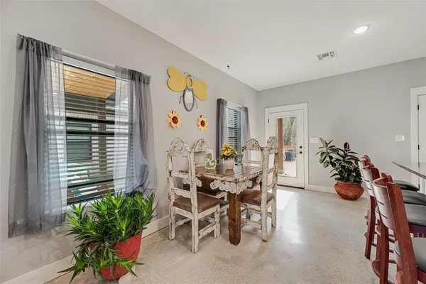 a living room with furniture a wooden floor and a window