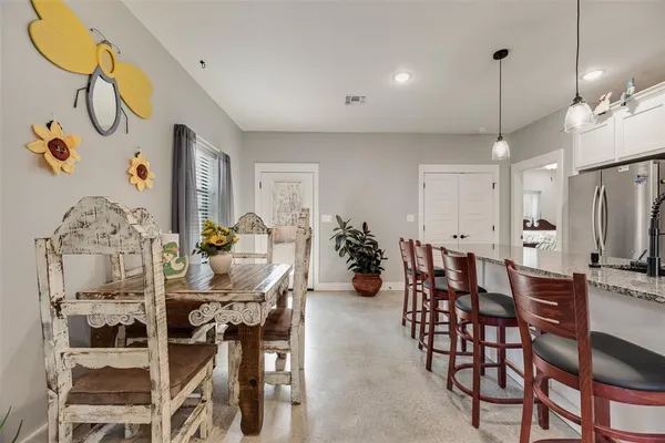 a large kitchen with granite countertop a sink a counter space appliances and cabinets