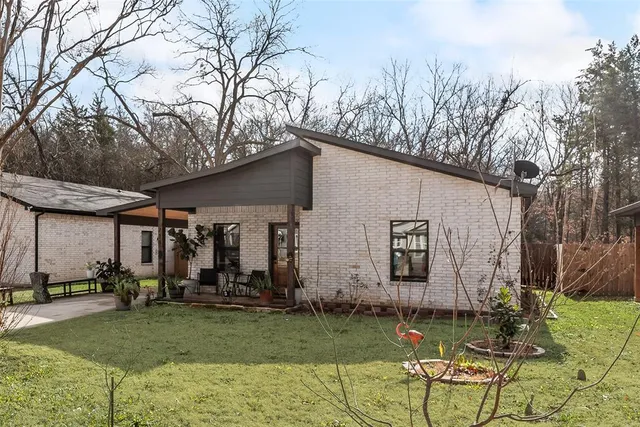 a backyard of a house with table and chairs