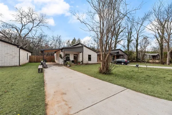 a view of a yard with a house and a tree