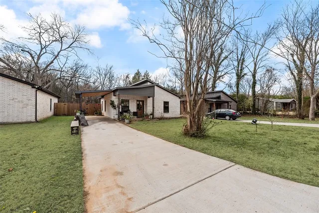 a view of a yard with a house and a tree