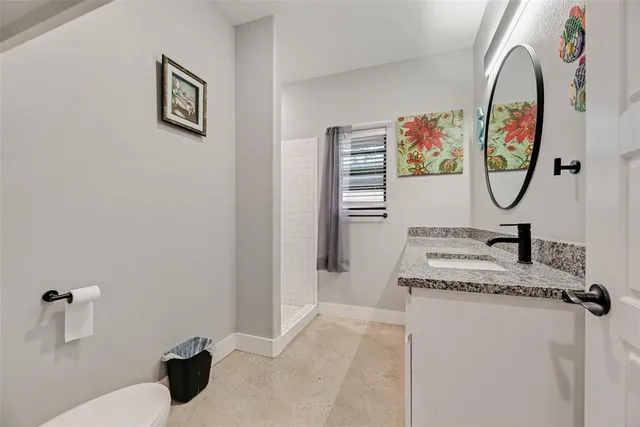 a bedroom with a bed and a potted plant