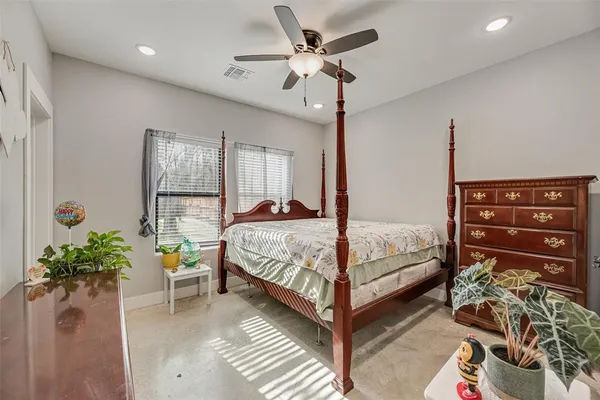 a bedroom with a bed and a dresser