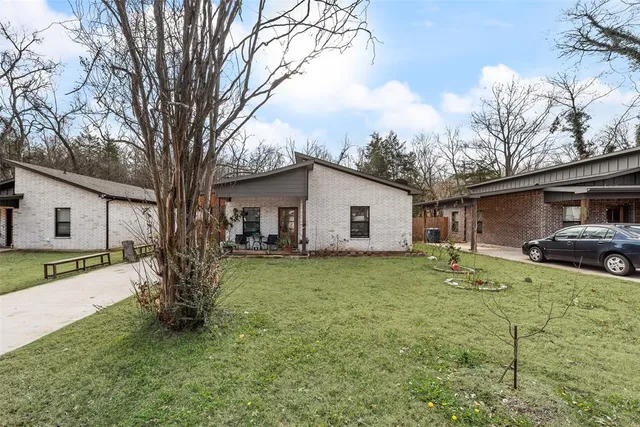 a view of a yard with a house and a tree