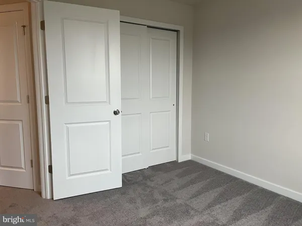 an empty room with closet area